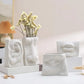 Vase visage humain
